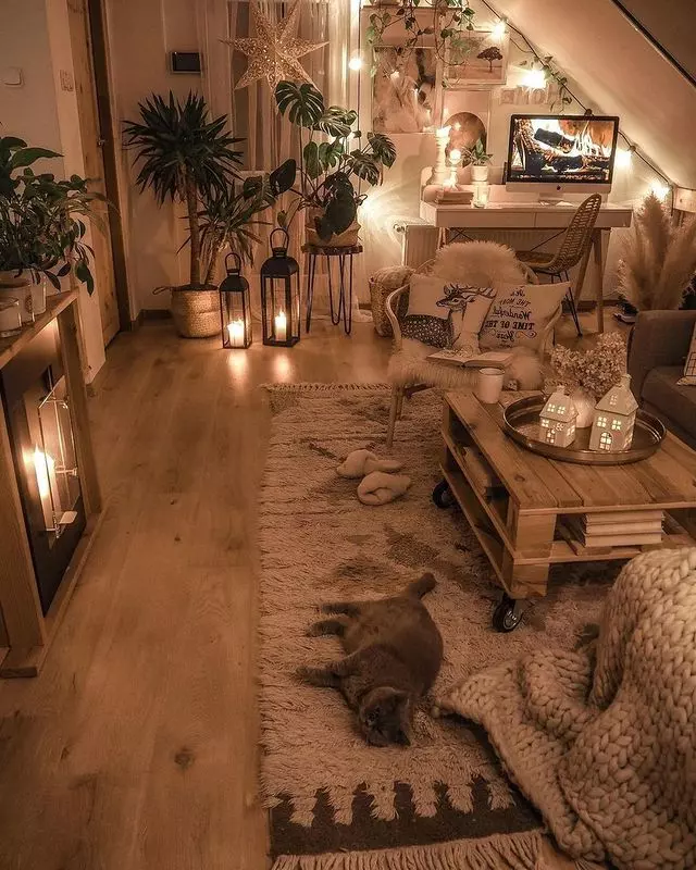 Experience the ultimate cozy ambiance with this chic and inviting living space, adorned with soft throws, warm lights, and lush greenery.