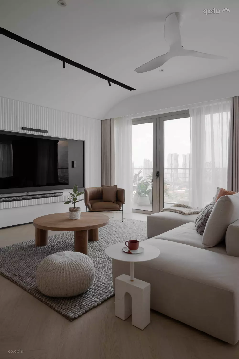 Experience subtle elegance in this airy minimalist living room featuring soft neutrals and modern furnishings.