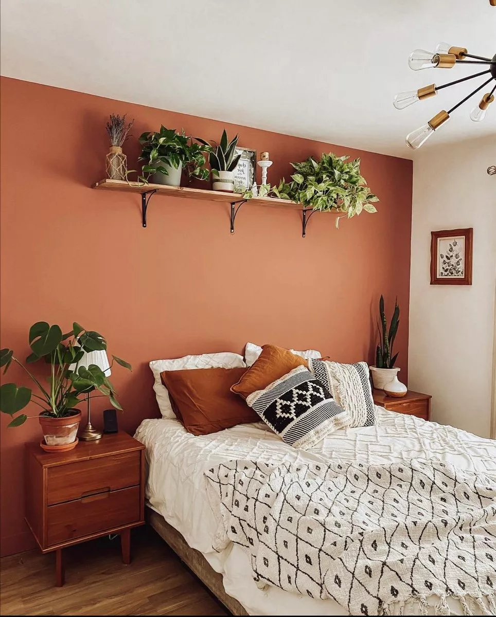 Discover a cozy bedroom where earthy tones and lush greenery create a serene oasis perfect for relaxation and rejuvenation.