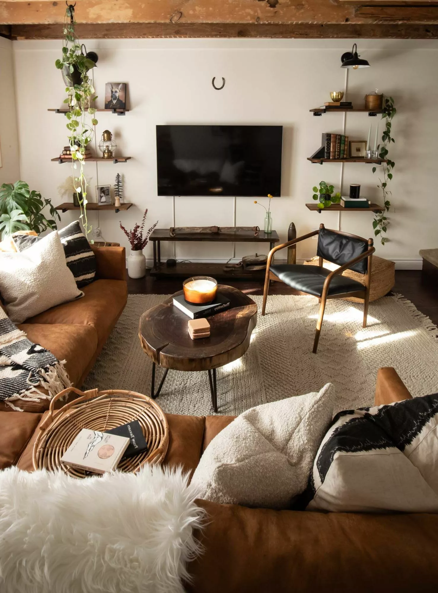 Discover a modern living room infused with rustic charm, merging sleek design and cozy elements for a stylish and welcoming space.