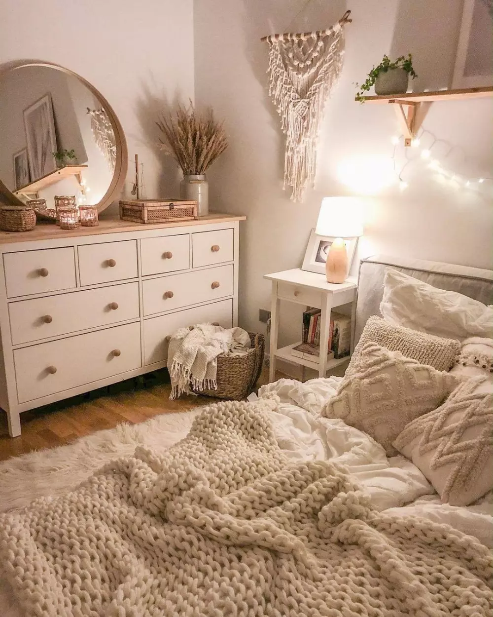 Experience true comfort with hand-knit blankets, woven accents, and warm lighting in this cozy bohemian bedroom setup.