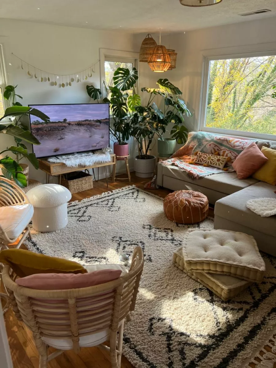 Step into a bohemian paradise with lush plants, cozy seating, and artisanal touches that make this living room a dreamy retreat.