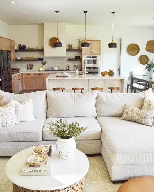 Experience tranquility with a modern rustic living room adorned in soft neutrals, warm wood accents, and stylish decor pieces.