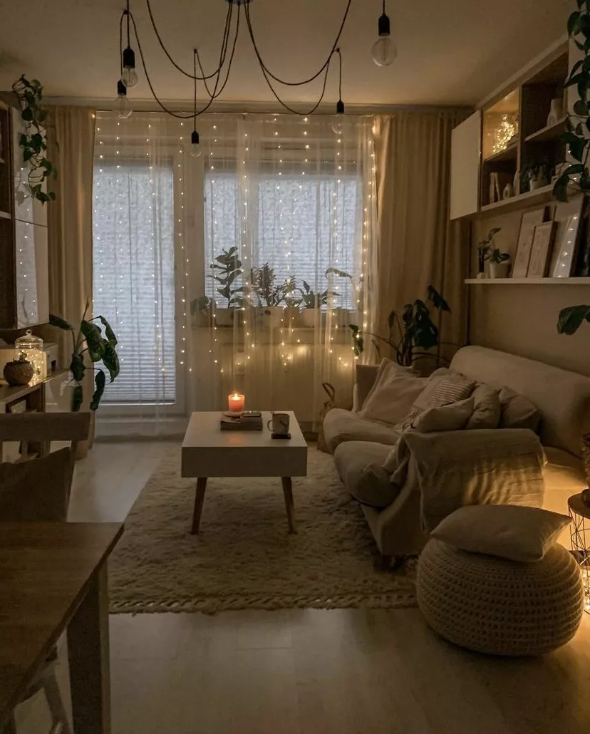 Discover the charm of a snug living space adorned with fairy lights, plush furnishings, and a warm, inviting atmosphere.