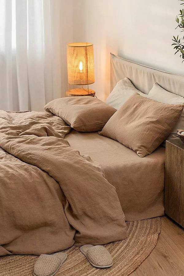 Discover the charm of this minimalist bedroom oasis featuring natural tones and soft textures for ultimate relaxation.