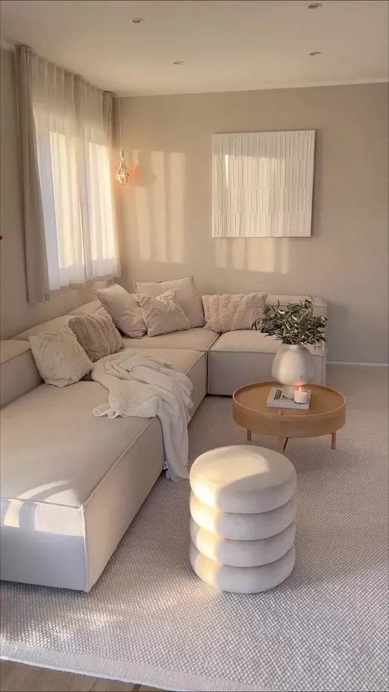 Discover the charm of this cozy minimalist living room. The neutral palette and soft textures create a serene retreat for relaxation.