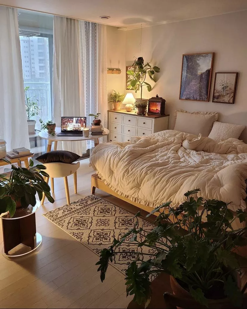 Experience tranquility at home with this serene and comfortable bedroom setup, featuring lush greenery, soft lighting, and thoughtful decor elements.