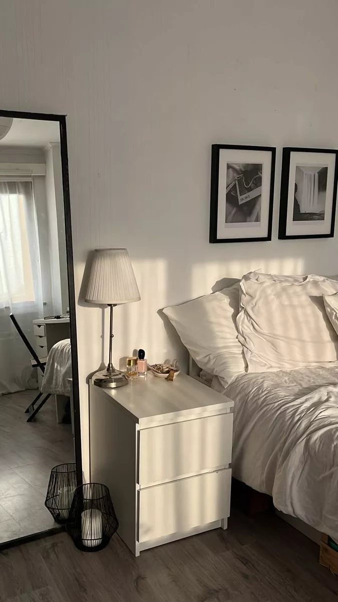 Step into an elegant haven of minimalism with this serene white bedroom, complete with chic decor and modern accents.