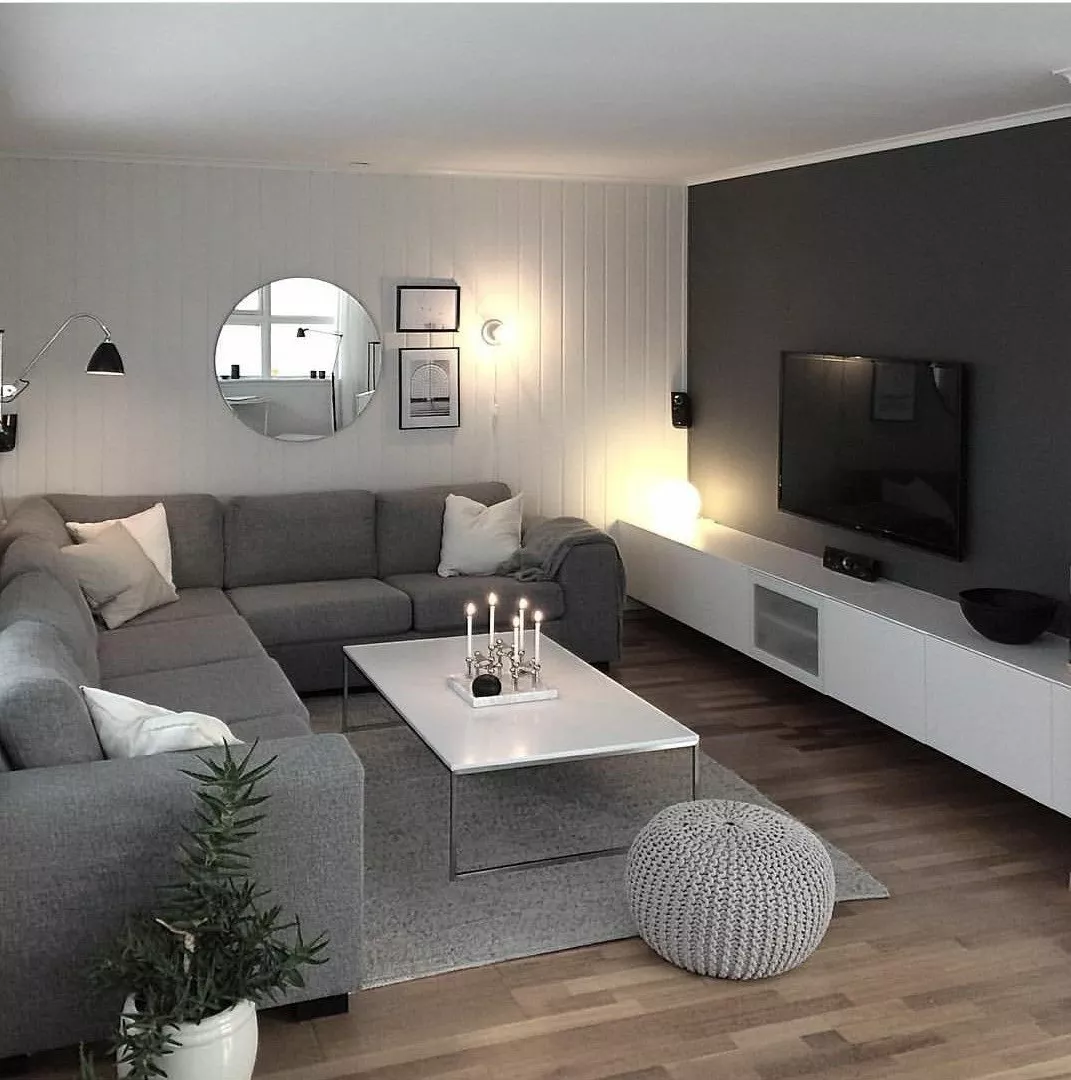 Discover the serene elegance of this modern living room with sleek furniture, muted tones, and stylish decor perfect for contemporary home styling.