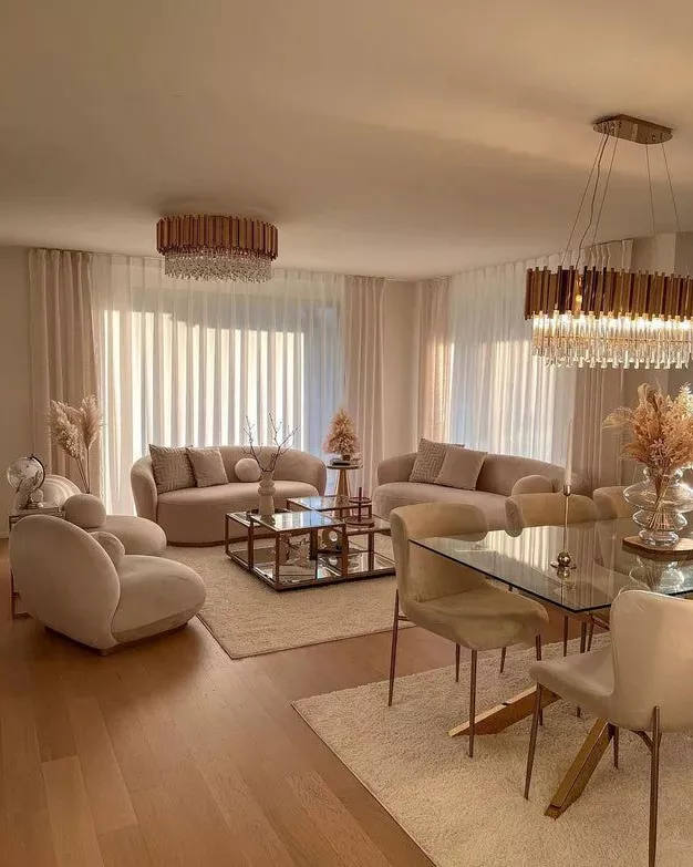 Transform your home with this serene living room design featuring plush furniture, muted tones, and sophisticated lighting.