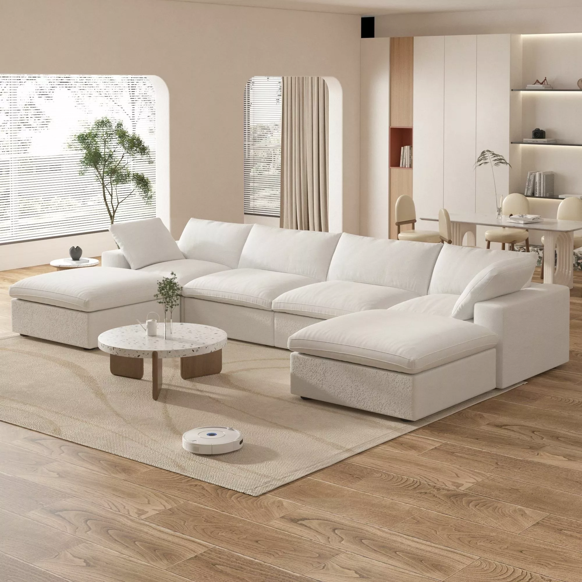 Explore the serene ambiance of a minimalist living room with plush white seating, natural light, and sleek furnishings - perfect for modern home decor.