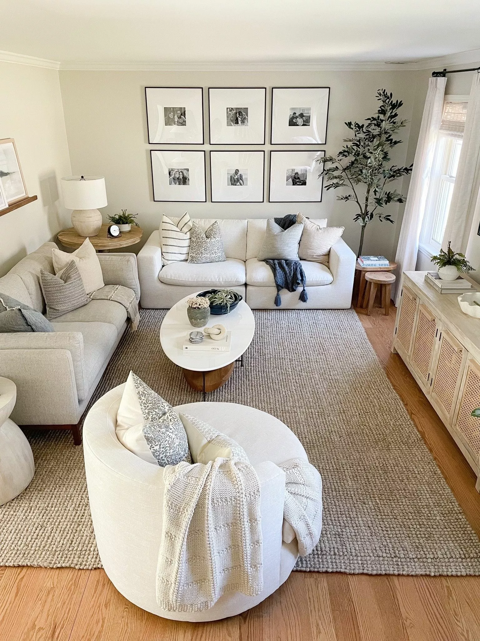 Dive into this beautifully designed living room featuring neutral tones, plush seating, and curated wall art for a touch of sophistication.