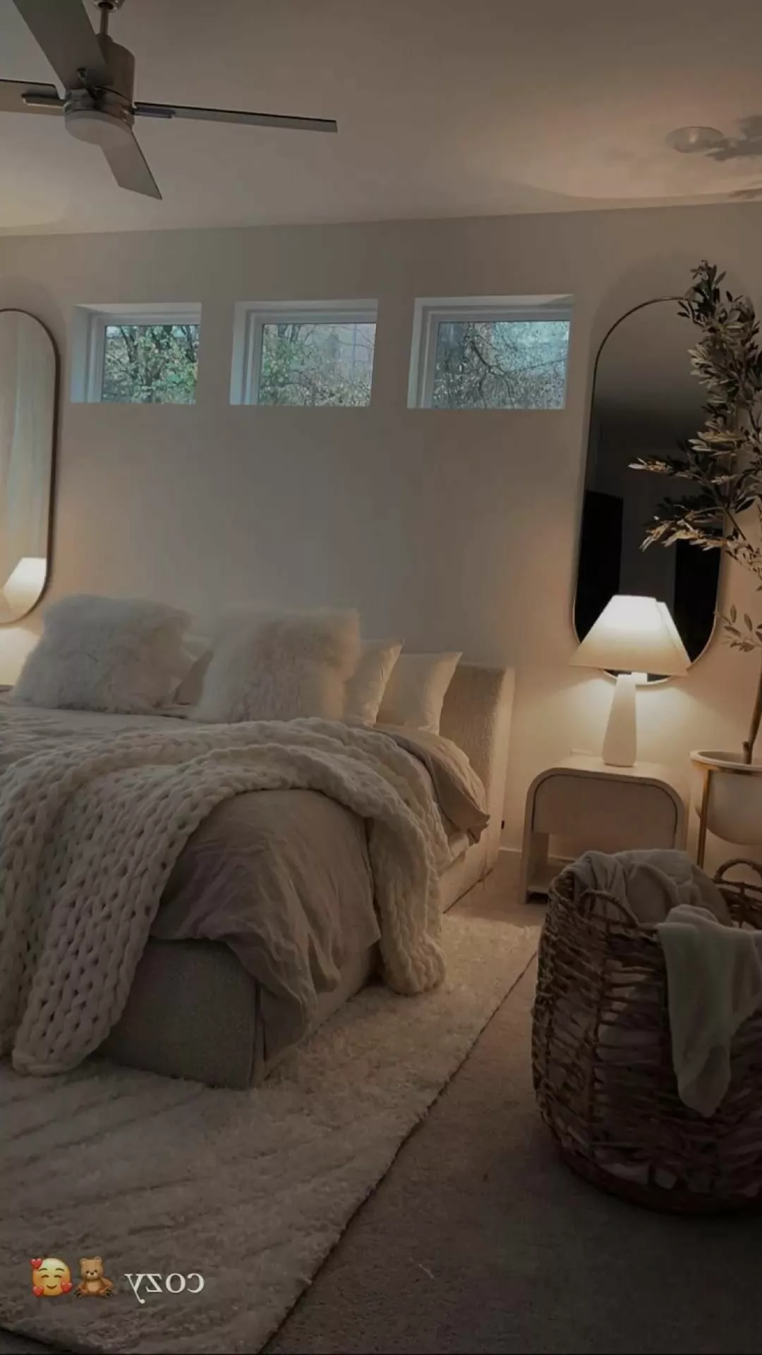 Step into serenity with this cozy bedroom haven, boasting plush textures and warm lighting.