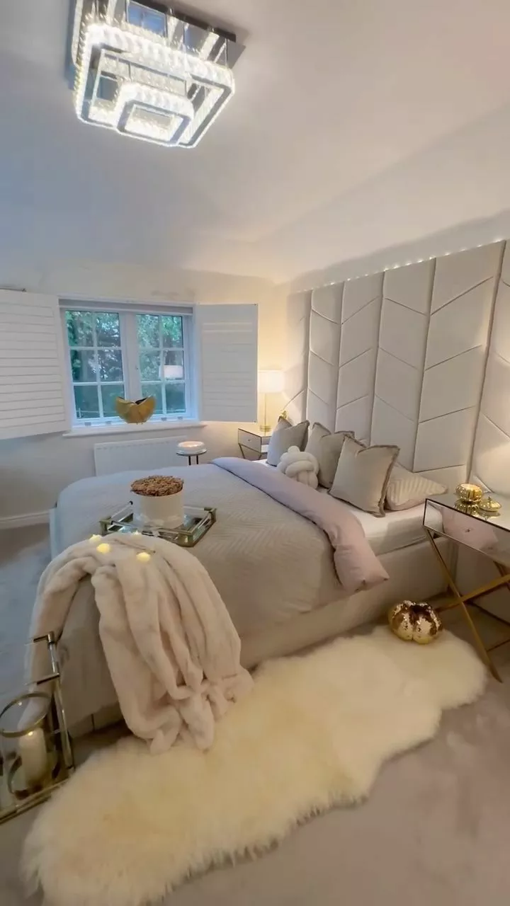 Explore this sophisticated and serene bedroom featuring plush decor, elegant lighting, and contemporary accents for a perfect unwinding space.