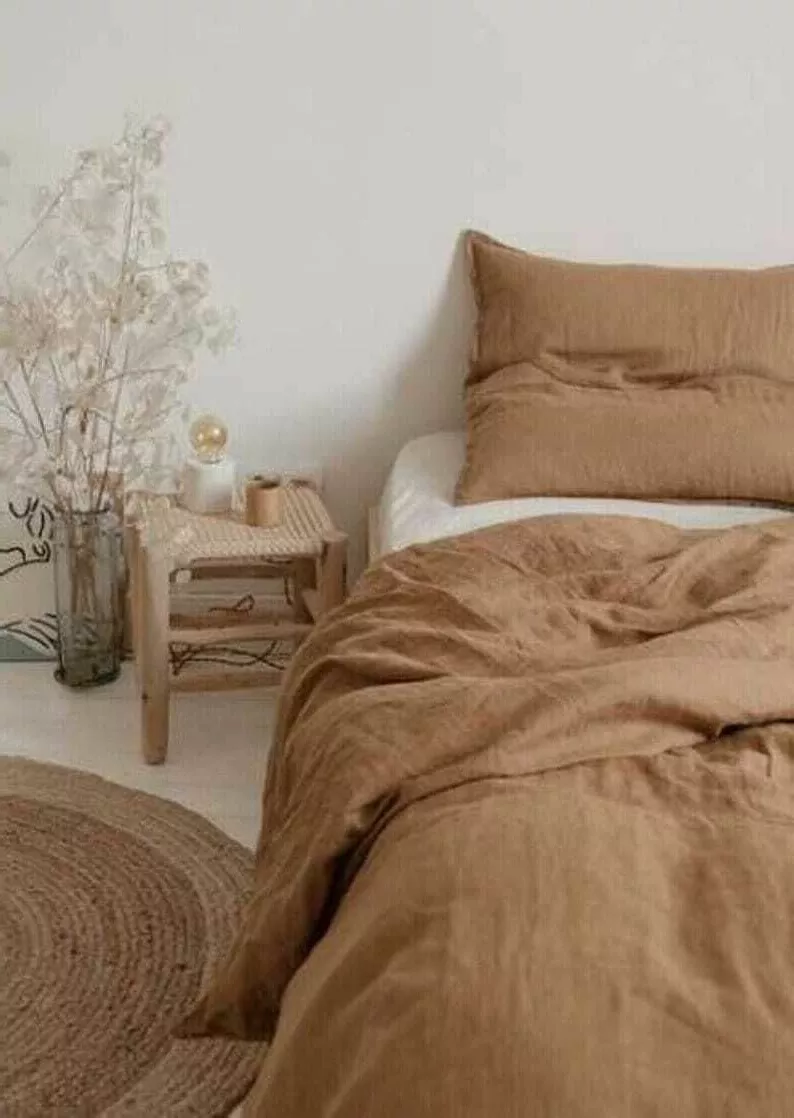 Transform your bedroom into a tranquil retreat with warm beige tones, soft linens, and natural textures for a soothing aesthetic that's both inviting and stylish.