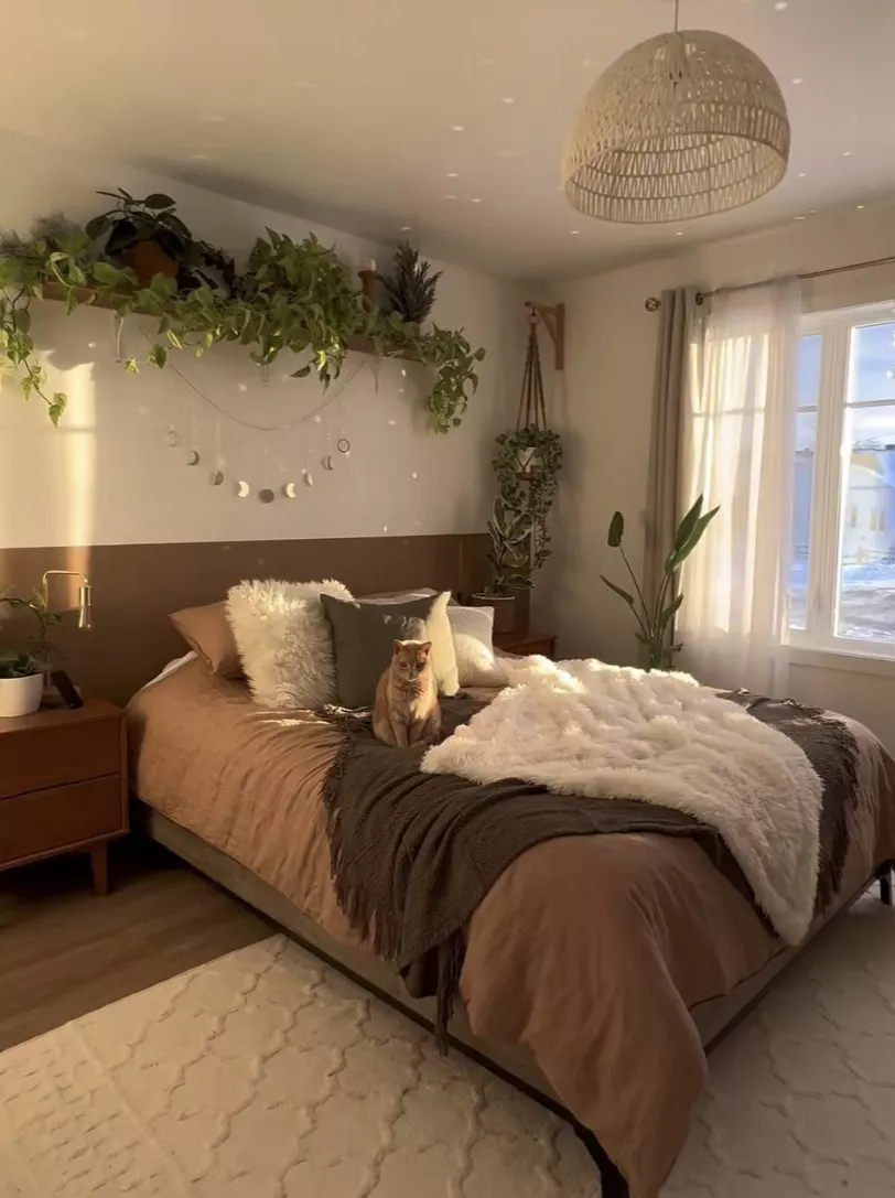 Relax in a serene earthy bedroom featuring cozy textiles, lush greenery, and warm accents.