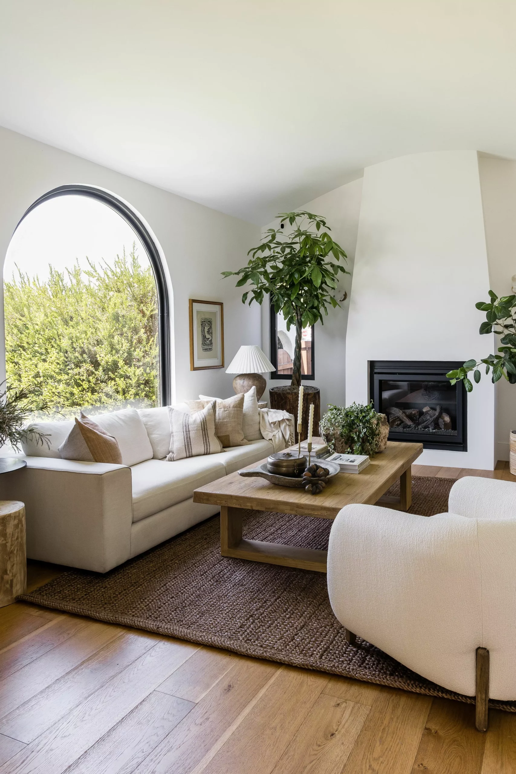 Discover the graceful charm of this living room, where neutral tones and natural light blend perfectly to create a soothing ambiance.