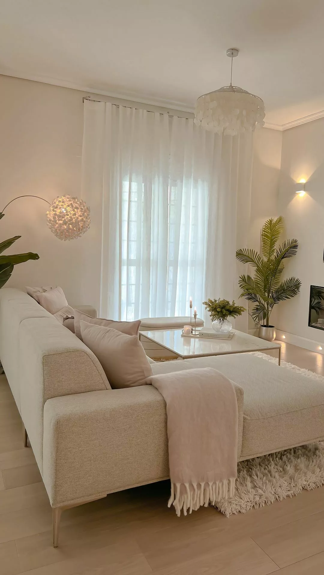 Discover the serene elegance of this modern minimalist living room, featuring soft hues, chic décor, and cozy elements perfect for a tranquil home retreat.