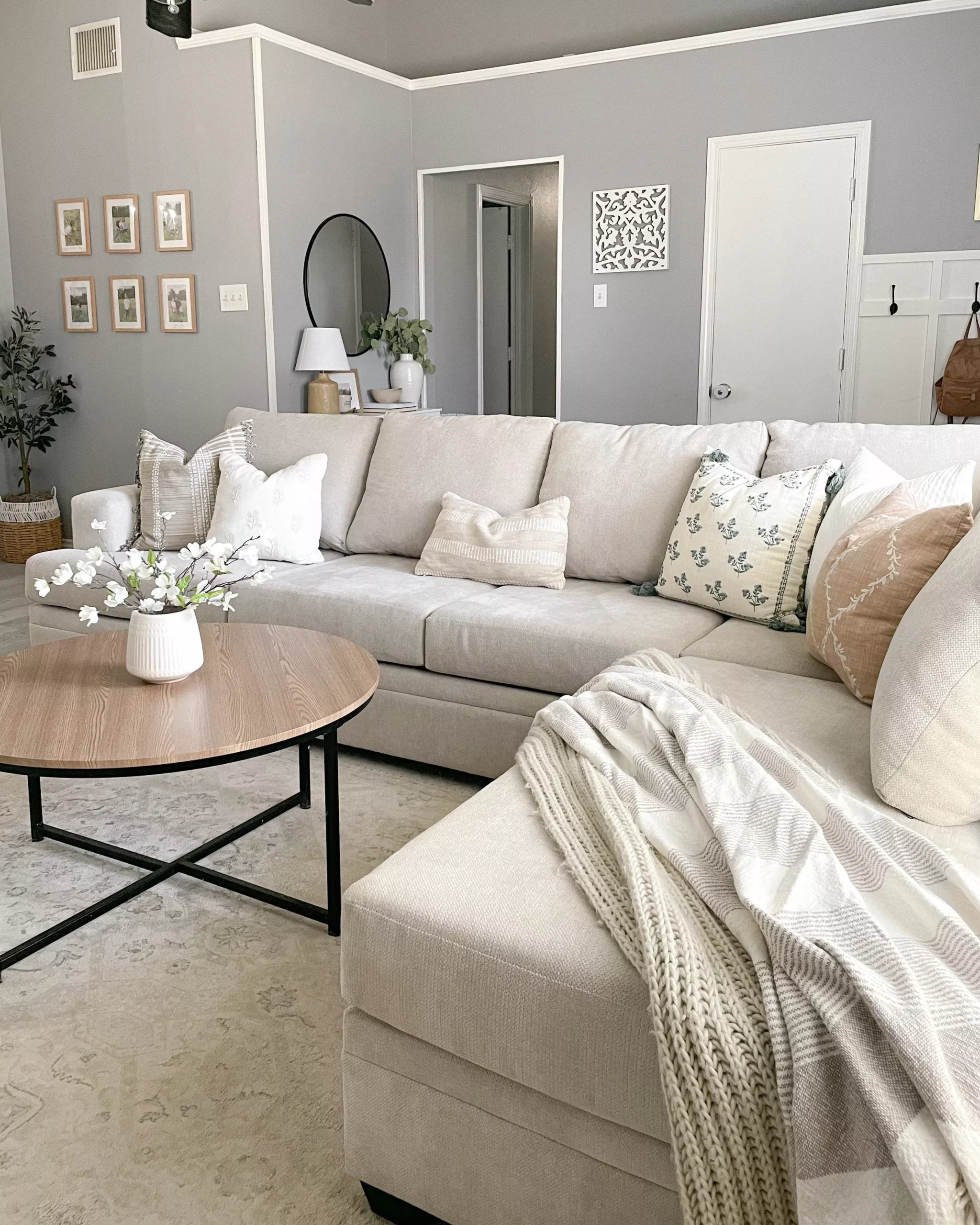 Discover a living room decorated in soft beige tones with plush cushions, elegant decor pieces, and a sense of serene comfort.