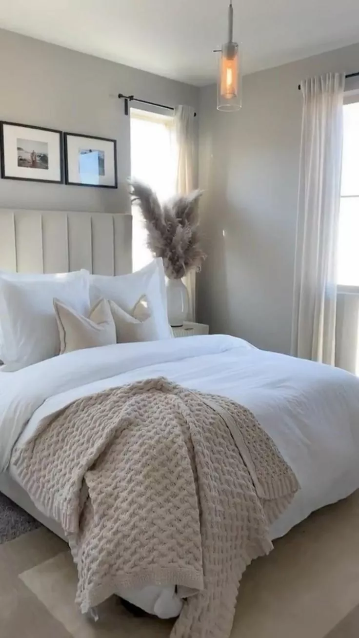 Discover the serene elegance of this modern bedroom, featuring soft beige tones, plush textiles, and thoughtful decor elements.