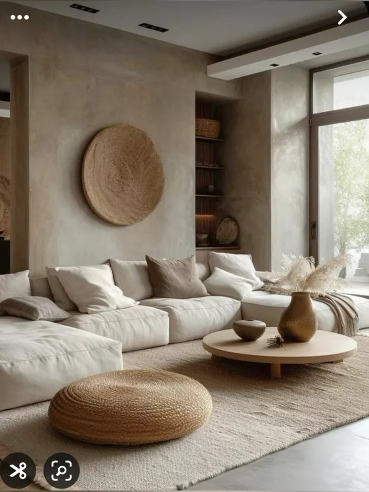 Experience tranquility in this minimalist living room with its earthy tones, cozy textures, and elegant design elements perfect for home decoration.