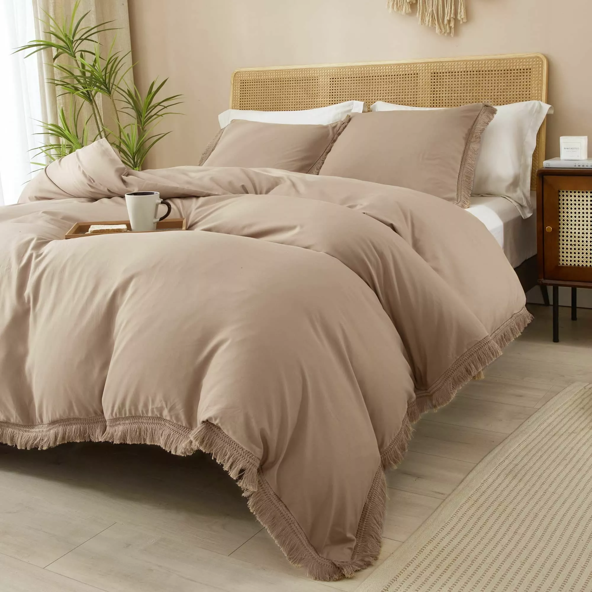 Transform your bedroom into a tranquil haven with this elegant beige comforter set, complemented by lush green plants and warm wooden accents.