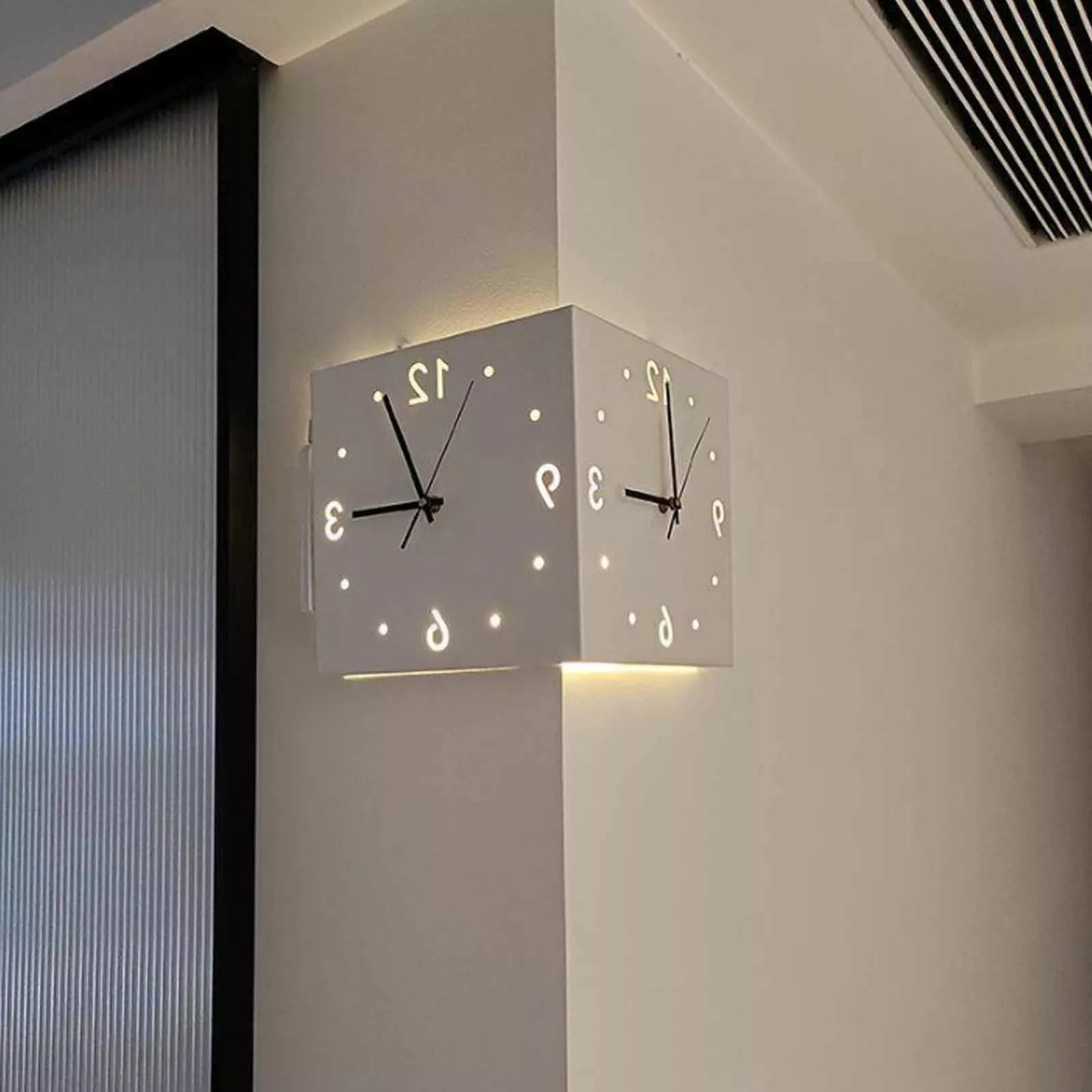 Modern dual-faced cube wall clock combines aesthetics and functionality, illuminating numbers creating a chic look.